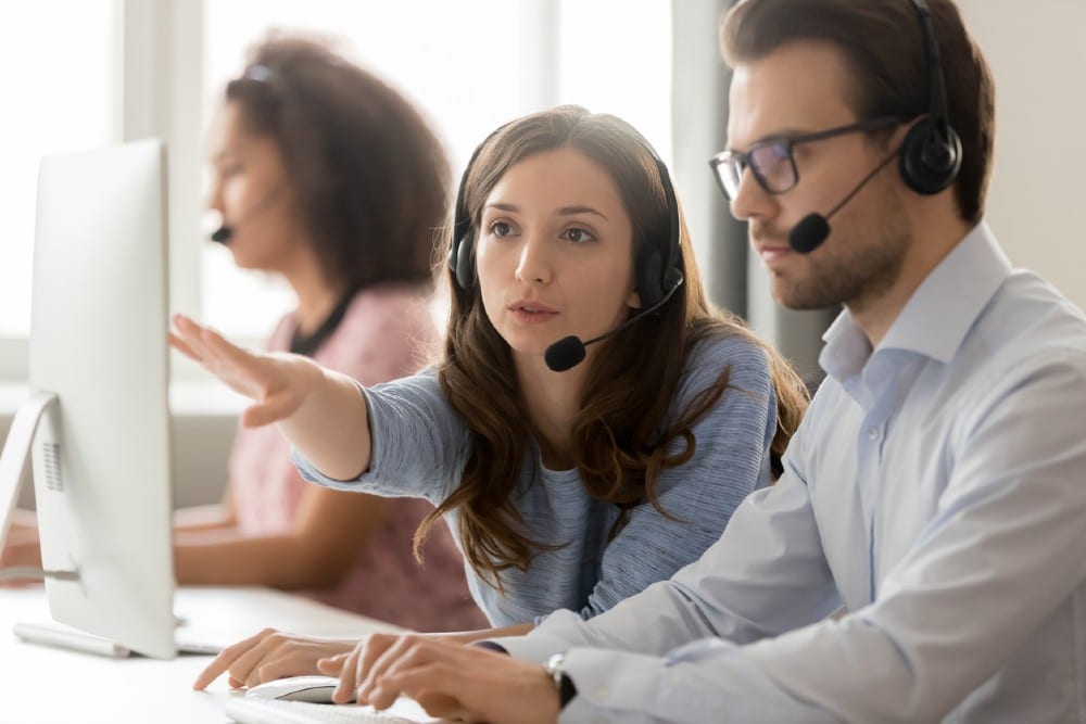 Customer service manager talking to agent.