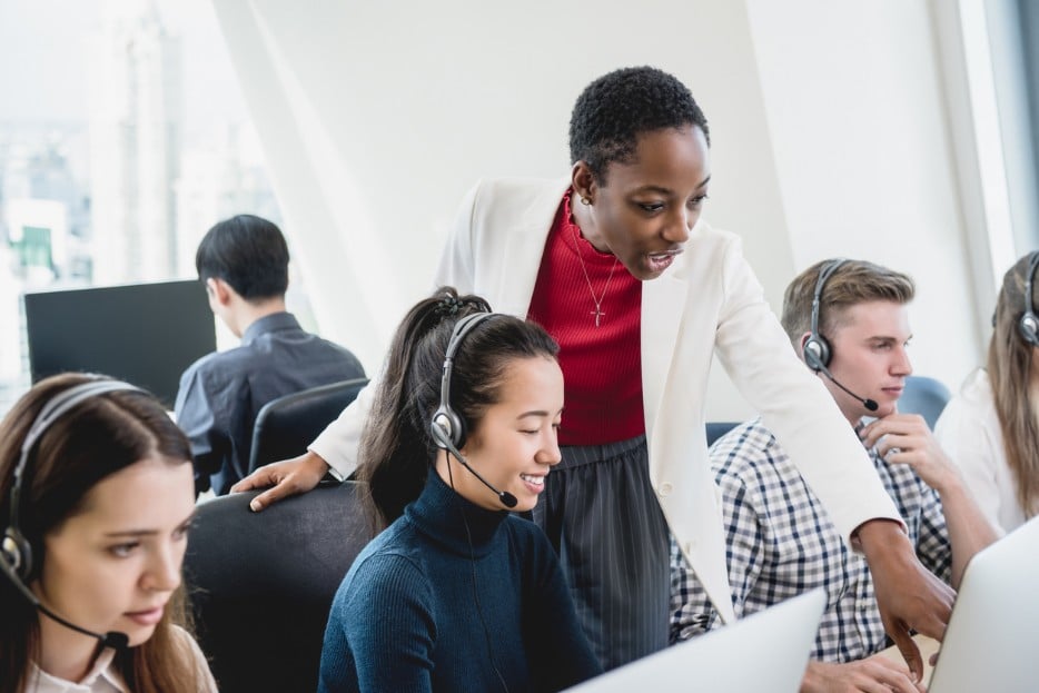 Call center manager talking to employees