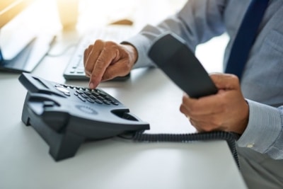 dialing on phone to call customer back