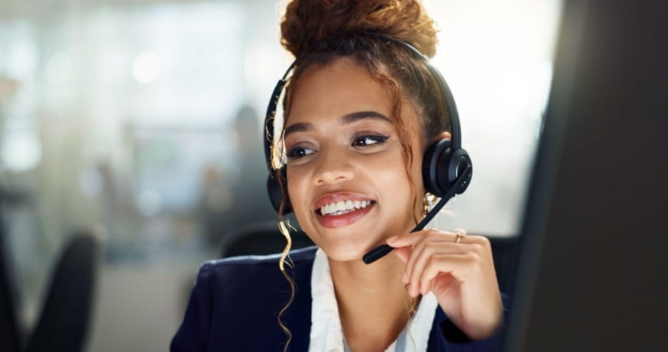 A call center agent provides cheerful customer service over the phone. A call center agent provides cheerful customer service over the phone.