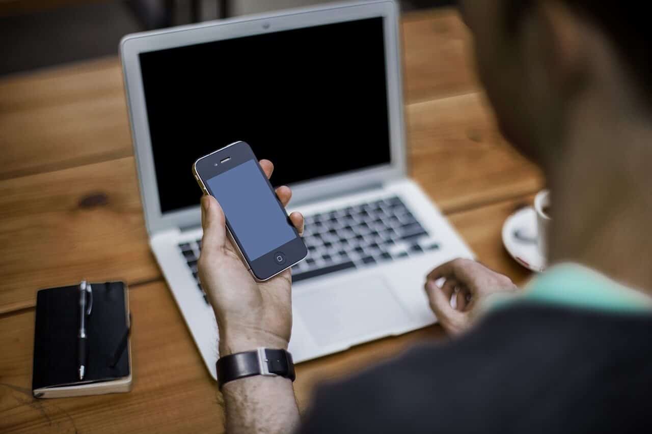 looking at laptop and phone