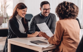 Couple consulting with a female financial manager at the bank