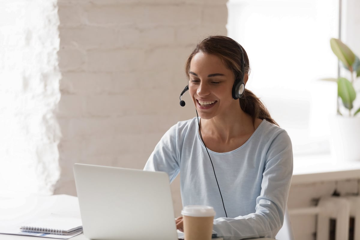 a call center manager weaing a headset, addressing staffing concerns