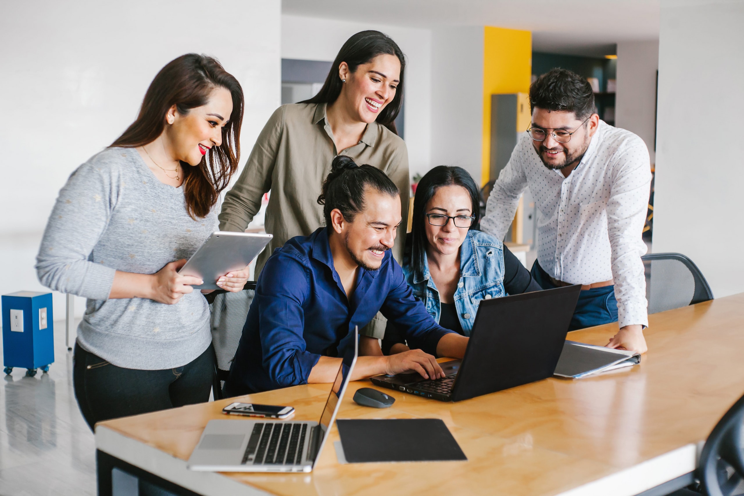 Group of business people working together as a team while sitting at the office desk.