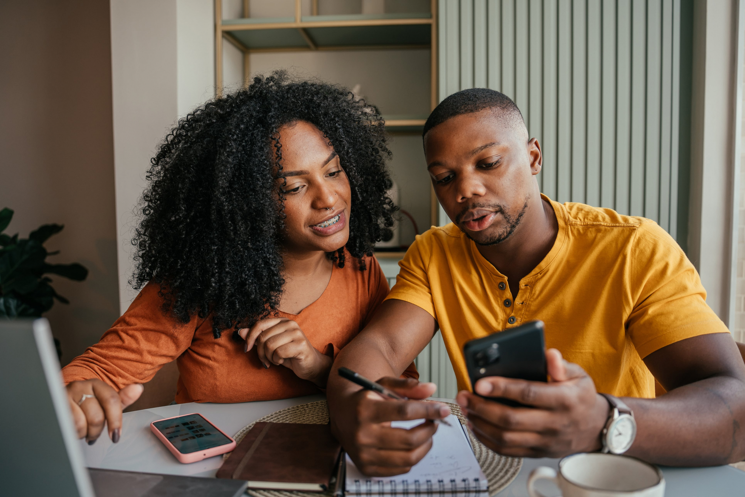 A couple sits down to look over their finances and notices a charge on their account that looks wrong.