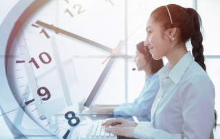 Call center agents with a clock to determine average handle time, or AHT.