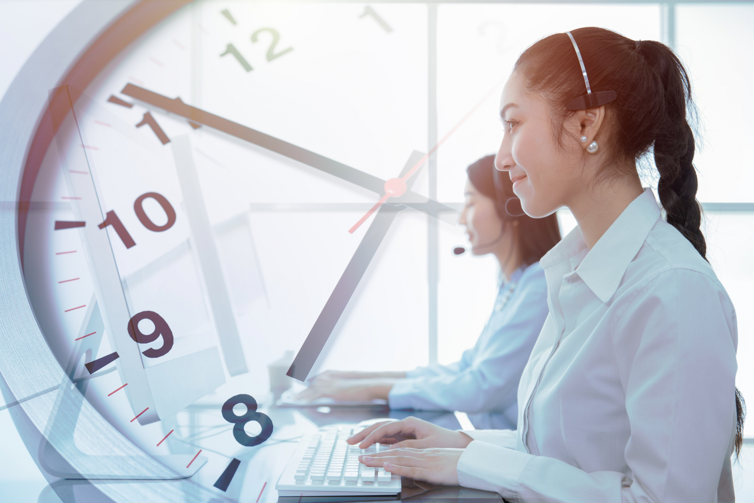 Call center agents with a clock to determine average handle time, or AHT.