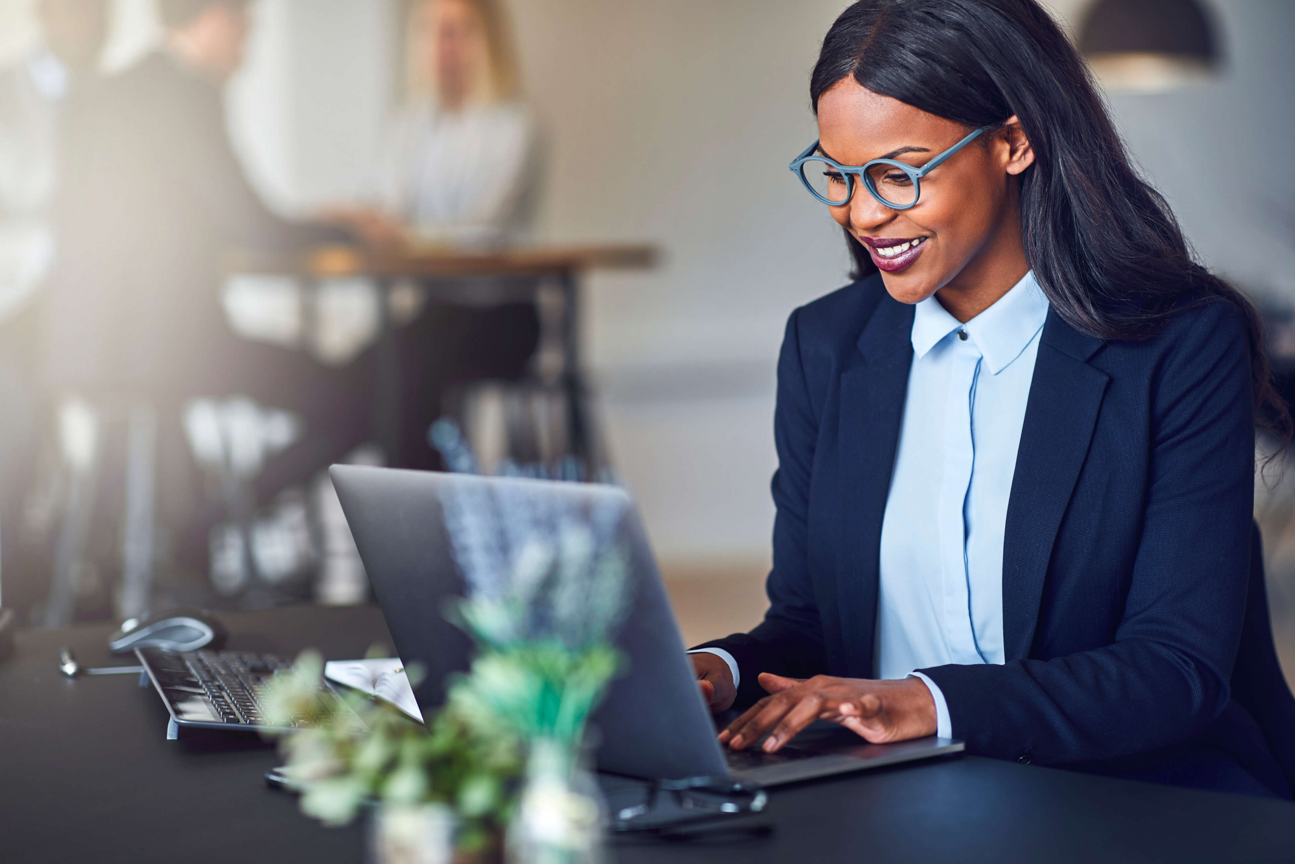 African American woman smiling on her laptop