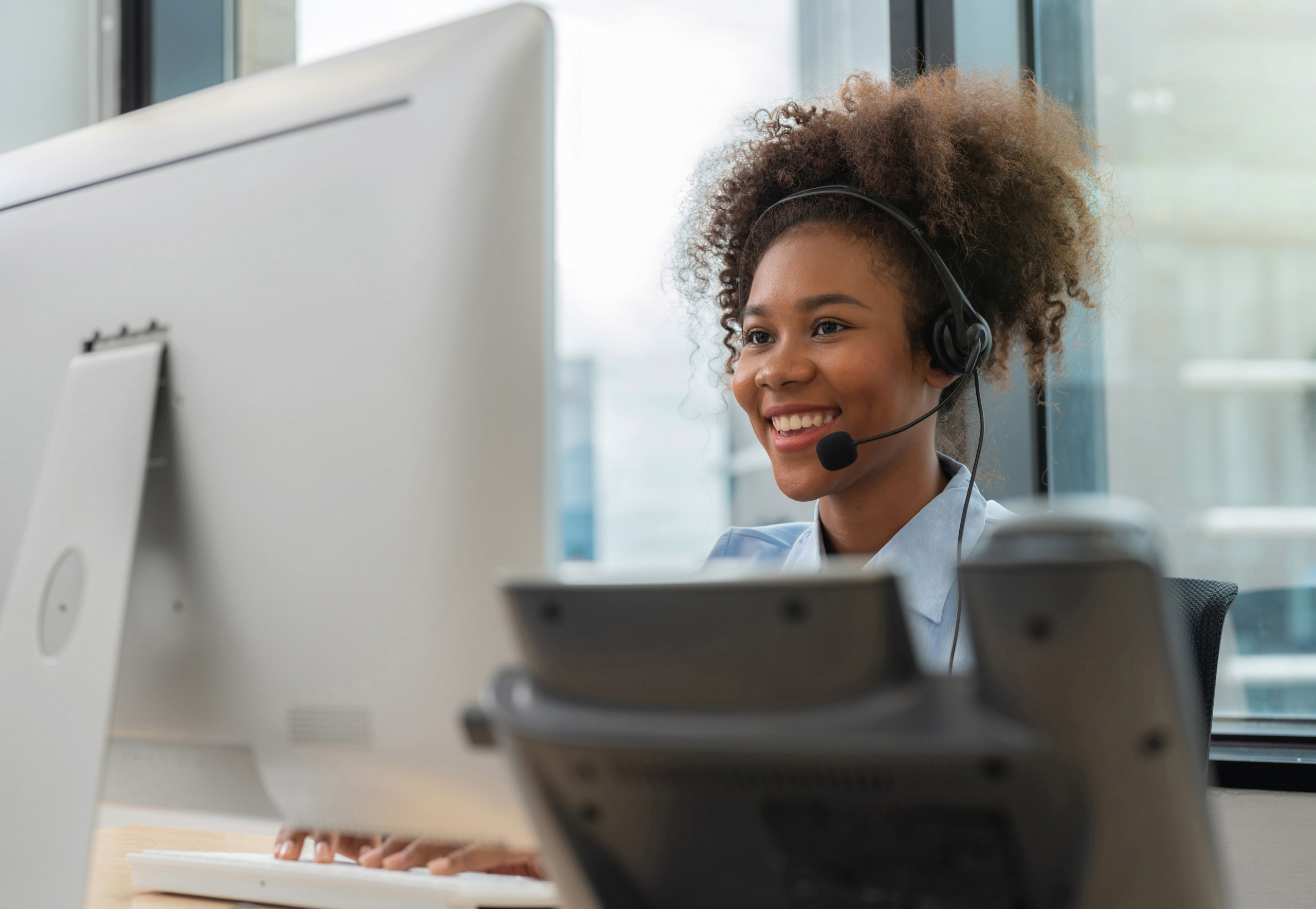 African American female call answering employee on her phone