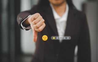 A CX agent with thumbs down and an overlay of a frowny face and 1 1-star review.